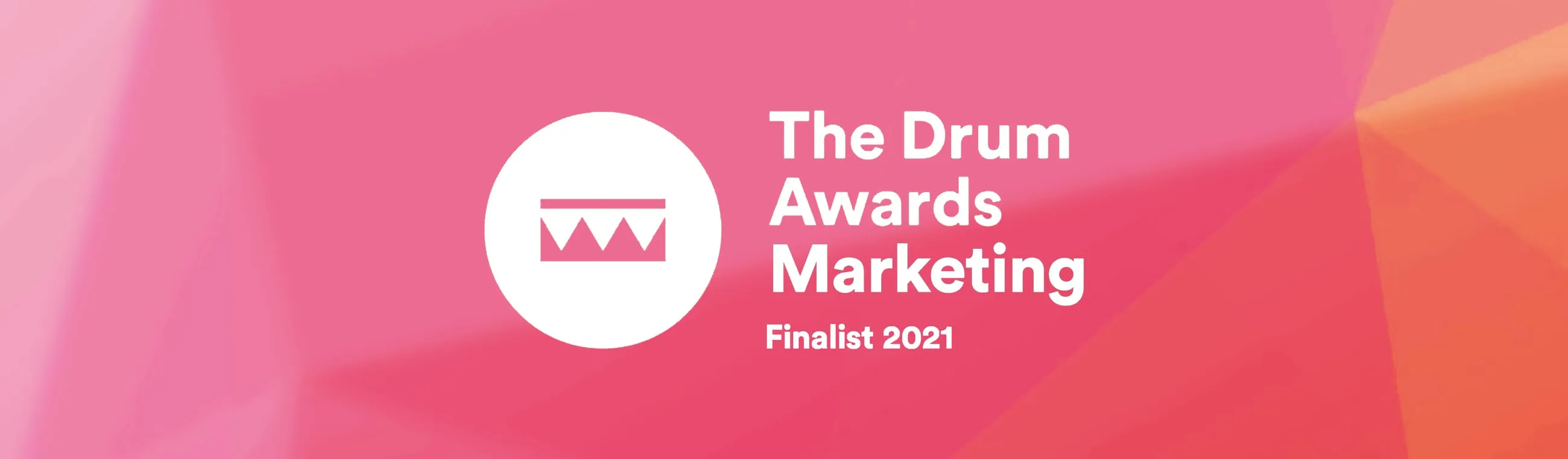 Red, pink and orange geometric pattern banner with 'The Drum Awards Marketing Finalist 2021' written in white text. As well as a Drum logo in the centre.