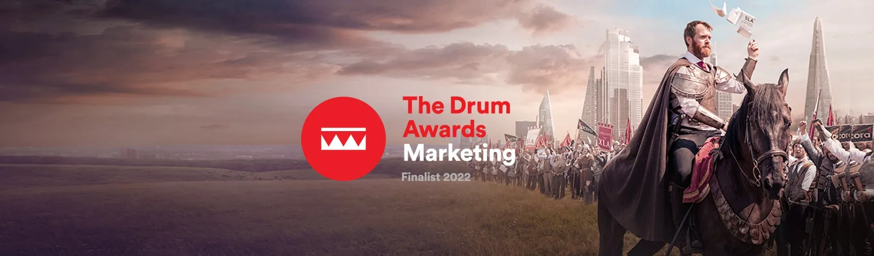 Acora hero image - a man in battle armour astride a horse with an army behind him, London city skyline in the background. The 'Drum Awards Marketing' Finalist 2022 logo in the centre.